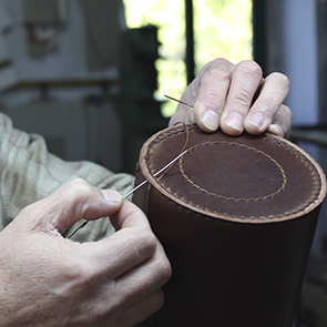 Leather bottle holder being sewn